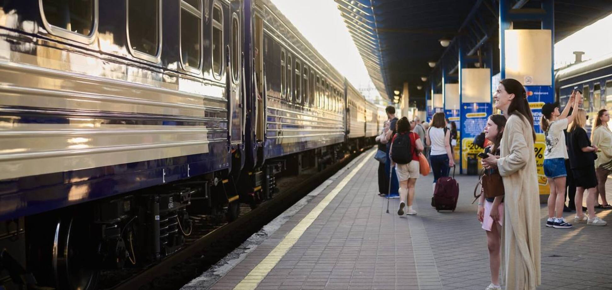 Пасажири очікують на свій потяг.